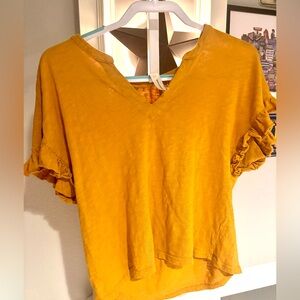 This is an Anthropologie Pilcro yellow ruffle sleeve T-shirt size small